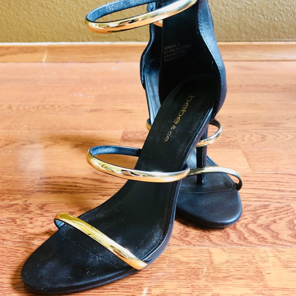 Black and gold BeBe strap heels